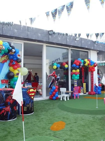 Here’s how I set up the outdoor area for a superhero party. There's plenty of space for games, with themed tables for the kids and a fantastic photo backdrop for everyone to enjoy.