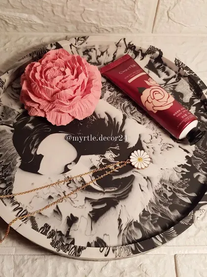 A classic black and white marble XL round tray. This timeless design is both elegant and modern.