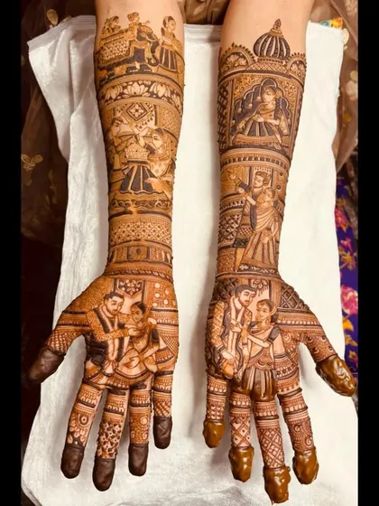 A beautiful example of narrative mehendi, this design includes portraits of the couple's family on the palms and various wedding rituals illustrated up the arms.
