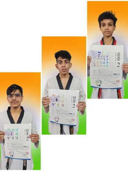 Students displaying their 2nd Dan and 2nd Poom certificates, showing their continued progress and commitment to the art of Taekwondo.
