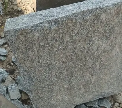 A large, rough-cut block of natural stone.