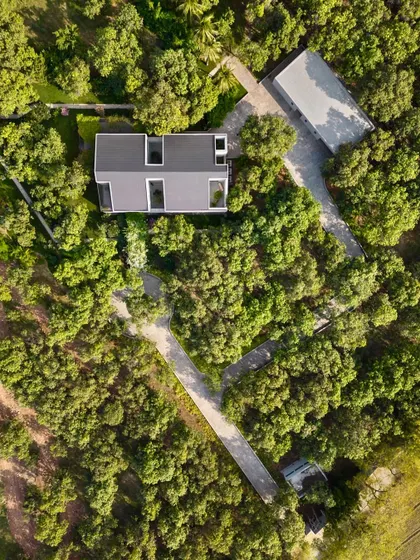 From above, the geometric layout of the house and its surrounding pathways becomes clear. The design is a thoughtful response to the site, creating a private residence that feels completely immersed in nature.