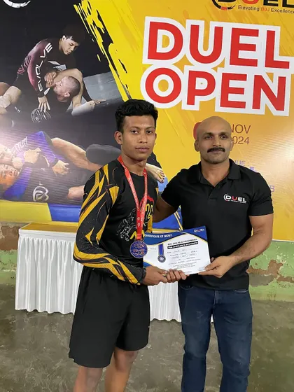 One of our young champions receiving his medal at the Duel Open. His hard work and perseverance have paid off.