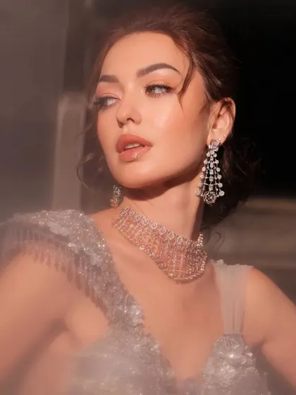 A dreamy, soft-focus portrait of a model in a silver-grey gown.