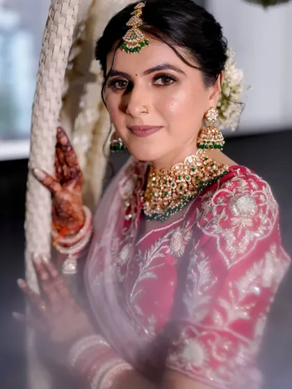 A beautiful portrait of our Gujarati bride. The makeup is subtle and elegant, allowing the intricate details of her red and white outfit to shine.