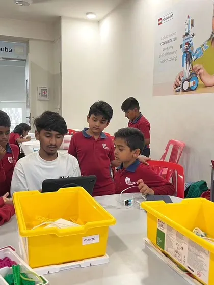 A group of Vidyashilp Academy students gathers around an instructor to learn a new programming concept, showcasing the interactive nature of our after-school sessions.
