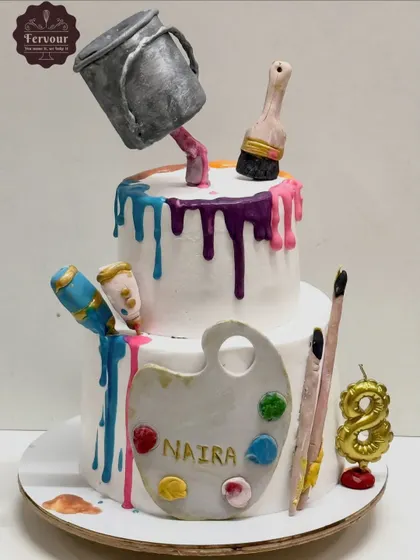 An example of my anti-gravity designs, this art-themed cake features a "floating" paint bucket pouring a colorful drip down the tiers. All the elements, including the palette and brushes, are handcrafted and edible.