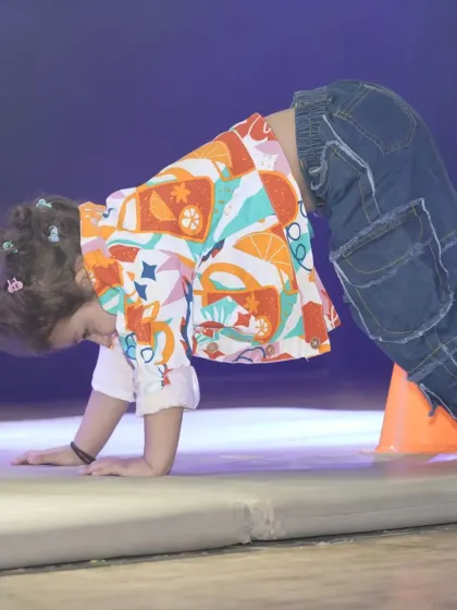 We incorporate foundational movements like crawling into our obstacle courses. This exercise helps develop a child's core stability and coordination, which are essential for both dance and overall physical literacy.
