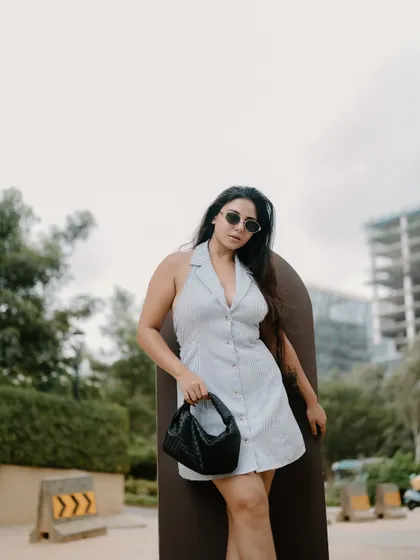 A duplicate of image 444, this full-length fashion portrait with the Bangalore cityscape in the background is stylish and contemporary.