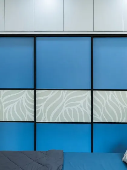 The sliding wardrobe in the 'Bohemian Bliss' master bedroom features a bold blue and white leaf pattern, making it a standout feature of the room.