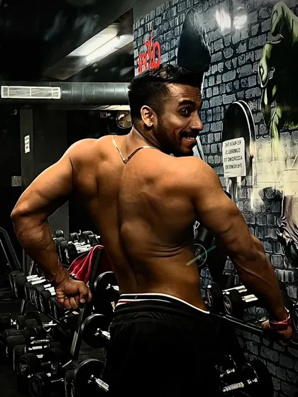 Another back pose, showing the results of countless pull-ups and rows. A strong, well-defined back is a sign of true strength and dedication.