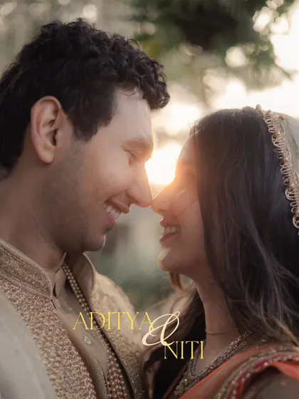 A classic sundowner portrait, with the setting sun creating a beautiful flare as the couple touches noses, their smiles radiant.