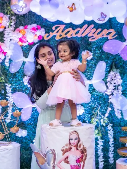 A sweet moment between mother and daughter at her first birthday party. These candid interactions make for the most precious photographs.