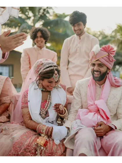 A candid moment of laughter shared between the couple and their friends during the wedding ceremony.