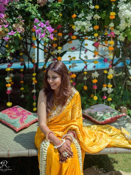 The bride looking radiant and happy, waiting for her Haldi ceremony to begin.