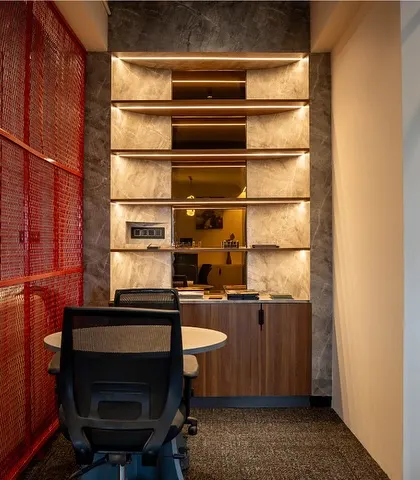 This close-up shows the built-in shelving with integrated lighting, perfect for displaying awards and decor, adding a personal touch to the workspace.