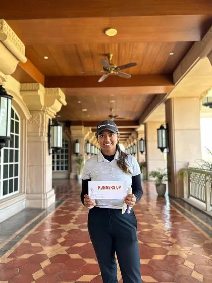 Rhea Jha proudly holds her "Runners Up" card after a commendable performance at Leg 5 of the Hero WPGT, showcasing her success in a competitive professional field.