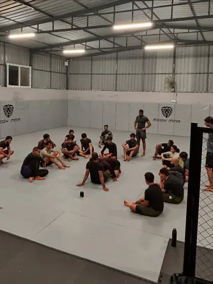 A typical Jiu-Jitsu session at Reign. The coach debriefs the class after a series of hard rolls.