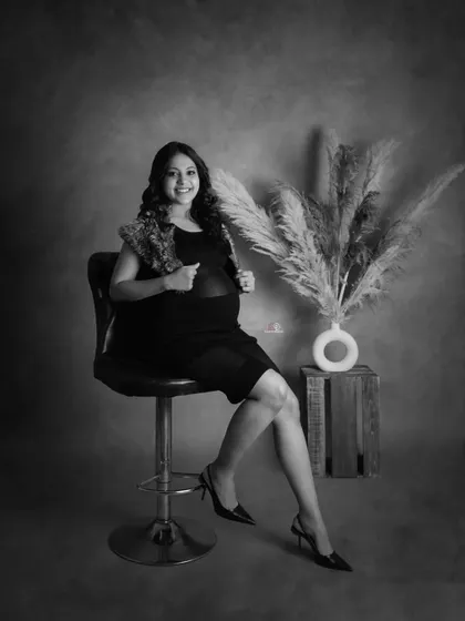This black and white portrait has a classic, glamorous feel. The mom-to-be looks confident and beautiful, showcasing a different side of maternity style.