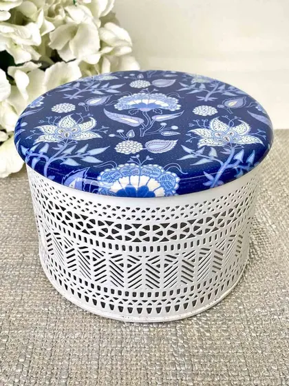 Experience the luxury of artful storage with our distinctive Samarkand Filigree Box. The intricate white metalwork and blue printed lid make it a stylish haven for trinkets or sweets.