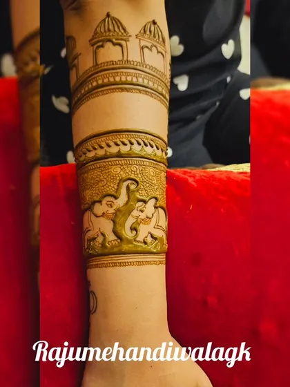 A close-up of an arm band with elephants, showing the fine details and shading.