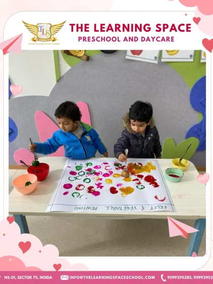 A wider view of the fruit and vegetable printing station. This setup encourages children to experiment with different items and colors, fostering scientific thinking and creativity.