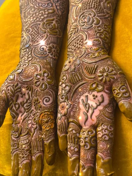 A close-up of the intricate details in a bridal palm, including custom lettering.