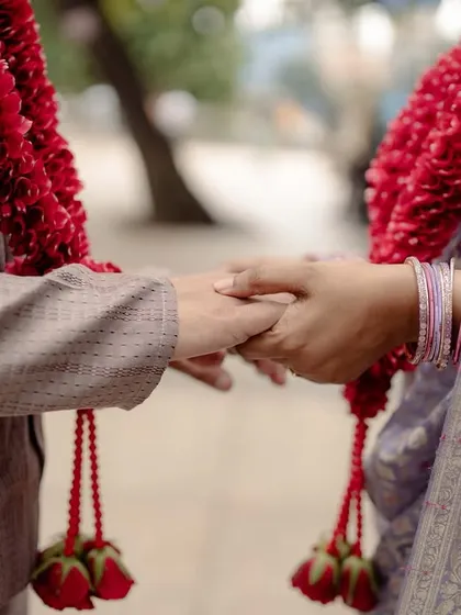 A close-up of the couple holding hands, a simple and powerful symbol of their legal and emotional union.