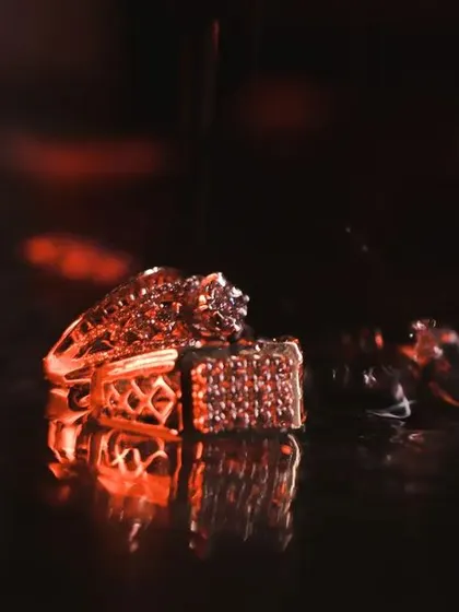 A dramatic and artistic shot of the wedding rings. I use creative lighting and reflections to turn a simple detail shot into a piece of art, perfect for including in a cinematic film.