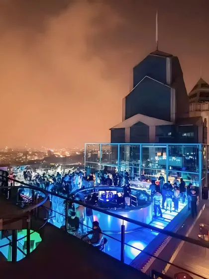 A beautiful shot of the Skyye lounge under a cloudy night sky, with the party going strong.
