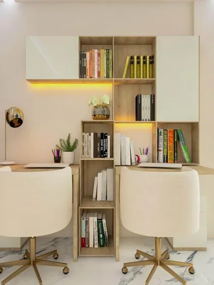 A bright and efficient study area for two, featuring a central bookshelf that separates the workspaces. The design uses light wood tones and white finishes to create an open and airy feel, conducive to focus and study.