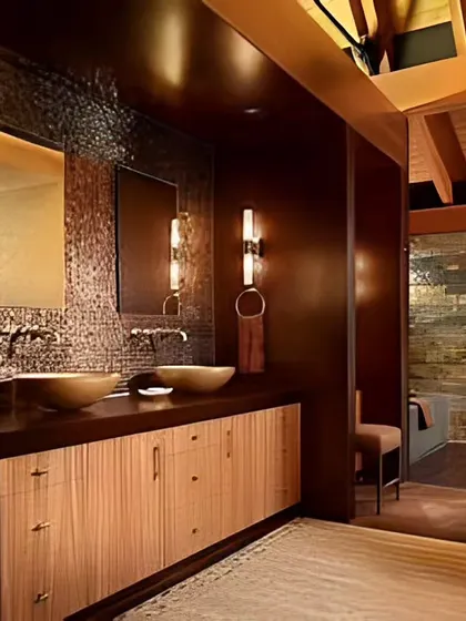A luxurious bathroom with dark, textured walls and a wooden dual-sink vanity. The warm lighting and natural materials create a rich and spa-like atmosphere.