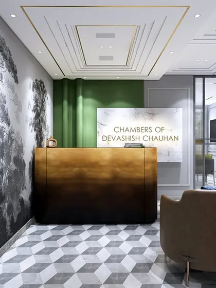 Another view of the lawyer's office reception, highlighting the geometric floor tiles and the contrast between the dark desk and the light, airy space. The design is professional and memorable.