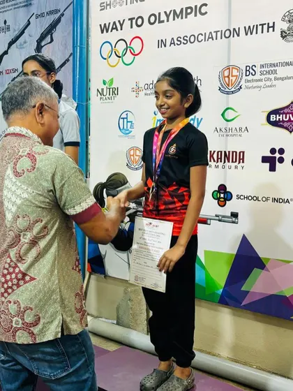 A young competitor receives her medal from G. Susheel, the Honorary Secretary of the Karnataka State Rifle Association, during our open competition.