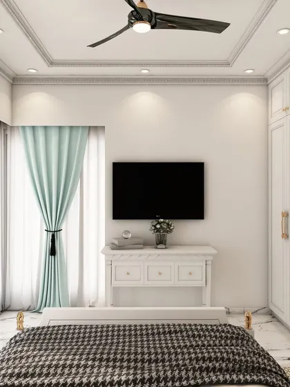 A view of the same traditional bedroom, showing the classic white wardrobe with mirrored panels and a simple, elegant TV console.