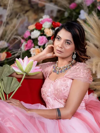 This portrait highlights the delicate details and soft color palette of the pink princess gown.