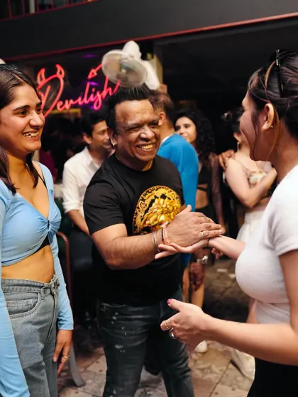 A candid moment of conversation with friends at the party.