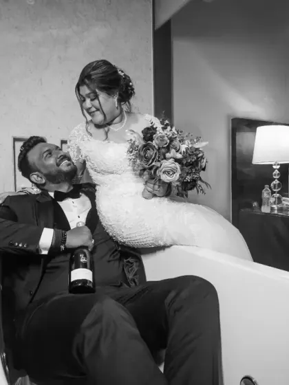 Who says you can't have fun in your wedding dress? This playful black and white shot in a bathtub is for couples who want to break tradition and create unique memories.