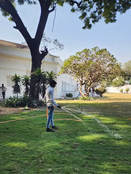 A snapshot of our lawn maintenance service in action at a large Delhi residence, ensuring the grass stays lush and vibrant.