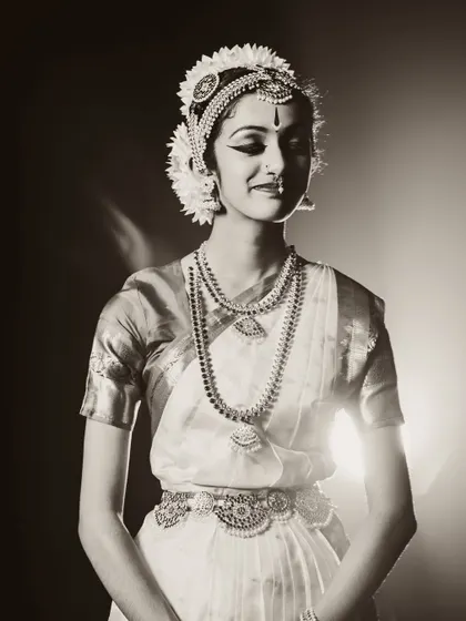 A beautiful portrait of a classical dancer. The sepia tone and soft backlighting create a nostalgic and timeless feel.