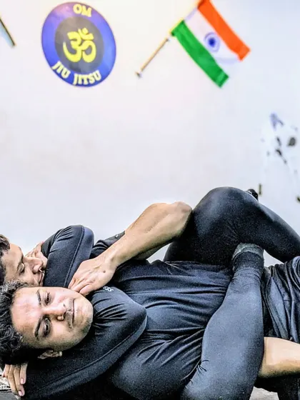 This is the chess match of martial arts. A student works to secure a rear-naked choke, a fundamental Brazilian Jiu-Jitsu technique that relies on precise control and leverage to safely subdue an opponent without strikes.