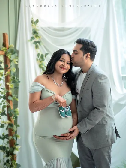 Incorporating tiny props like these baby shoes adds a touch of sweetness and anticipation to your couple portraits.