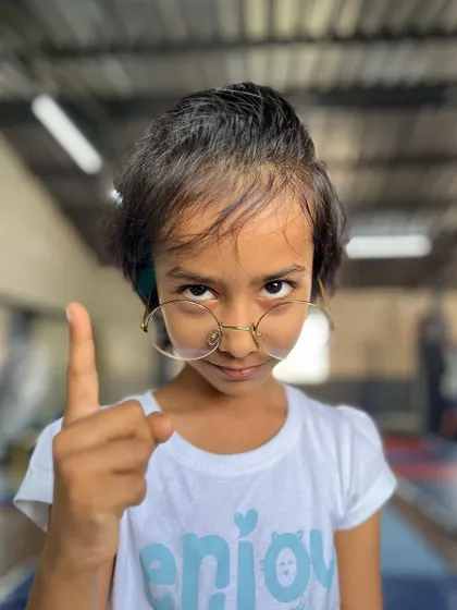 A sister will turn into a tiger if her sibling is in trouble. This student strikes a fun, boss-like pose, showing her playful and protective side.