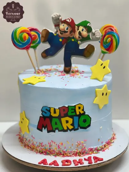 A fun Super Mario-themed cake with Mario and Luigi on top. The cake is decorated with colorful sprinkles, fondant stars, and lollipops, creating a playful and festive look.