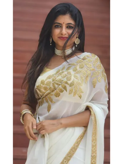 The wind in my hair while wearing a beautiful white and gold saree.