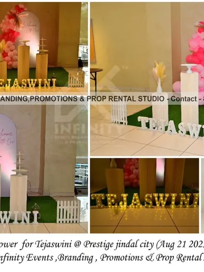 A simple and elegant baby shower at Prestige Jindal City Clubhouse. The decor features a pink and white color palette with a semi-arch backdrop, a balloon garland, and cylinder tables, creating a chic and modern celebration for the mom-to-be.