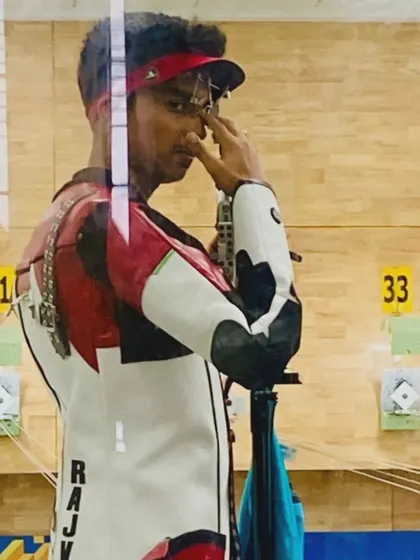 A candid shot of our shooter Rajveer, focused and in the zone during a competition.
