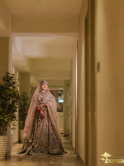Another beautiful shot of the bride in the hallway, capturing her elegance from a distance.