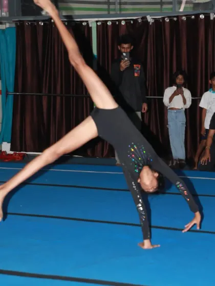 A powerful cartwheel performed during a student showcase. You can see the focus and determination as she performs in front of an audience.