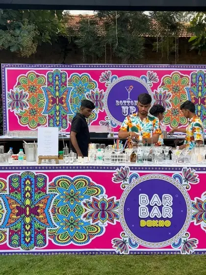 A quirky and colorful "Bar Bar Dekho" counter for a carnival-themed event, featuring vibrant patterns and a fun design.